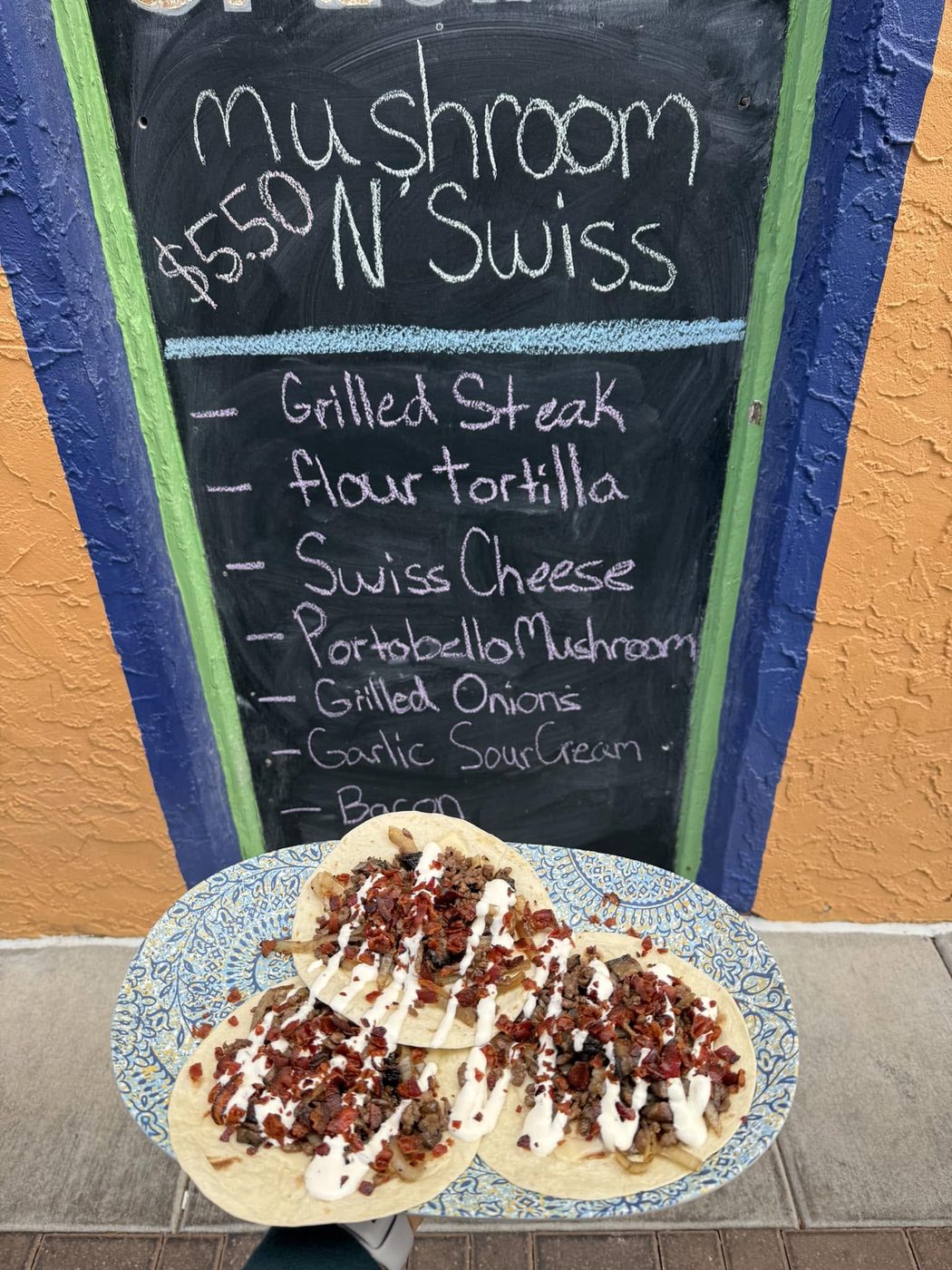 Mushroom N Swiss in front of the specials board
